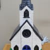 Lighted, Ceramic- glazed white city church. These churches are crafted in Shelbyville