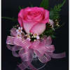 A pink corsage is a delicate floral accessory that radiates charm and