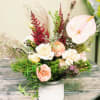 A delicate mix of dried and fresh flowers. Arranged with blooms that