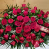 The Red Rose Half Casket Spray by Savilles Country Florist is a