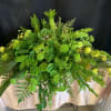 Take a natural look with this all green flower casket for your