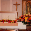 This couple includes the casket arrangement and garland in warm peach tones.