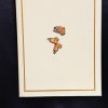 Beautiful textured ivory card adorned with two delicate orange monarch butterflies in
