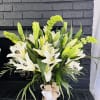 Melody, A serene and refined arrangement of pure white oriental lilies embraced