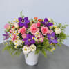 A poetic blend of violet tulips, blush roses, chamomile, and creamy lisianthus