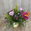 Colorful mix of blooms with butterflies fluttering around. Flower colors and types