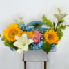 A harmonious blend of vibrant sunflowers, delicate pale blue flowers, and timeless