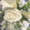This bouquet is designed with White Roses, White Snapdragons, White Campanulla, White