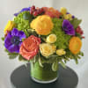 An exquisite and modern styled arrangement of our brightest colored blooms from