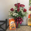 12 red roses arranged in glass vase w/ 30 oz. container of
