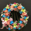 This wreath make with lily , roses, carnations, alstroemeria and pompom