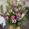 Stunning purple roses surrounded by pink snapdragons, beautiful bells of Ireland that