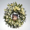 A timeless circle of peace and remembrance, this all-white mixed wreath surrounds