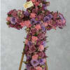 This artfully put together cross in different tones of purples and pinks