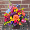 In vibrant, bold colors and arriving in a cube vase, evoking joy