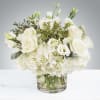 New beginnings deserve flowers! This all white arrangement includes roses, lisianthus and