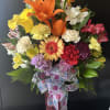 fresh mix of flowers in long tall vase 