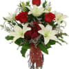 This fragrant Bouquet includes fresh white lilies and vibrant red roses. Accented