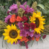 Summer Soiree featuring the sunflower mixed with roses, carnations and daisies