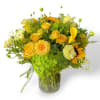 This arrangement has yellow roses, sunflowers, spray roses, calla lilies, butterfly ranunculus