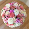 This luxurious floral arrangement combines delicate pink roses, pristine white blooms, and