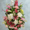 A grand, vertical floral tribute, meticulously arranged to convey profound sympathy and