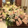 A beautiful full casket arrangement in different tones of pinks and whites