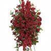 This striking spray features a bold combination of red roses, carnations, and