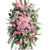 A soft and graceful spray featuring all-pink lilies, carnations, and stock. This