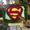 Custom shield wreath using carnations with anthurium and orchid cascade.  