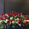Strong contrast and impact of red roses and carnations intermingled with white