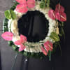 Artfully arrangements of pink &amp; green Anthuriums on eternal circle of white