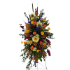 This standing spray has sunflowers, delphenium, roses, dahlias, stock, hydrangea and solidego.