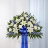  Our majestic blue and white standing basket arrangement will help honor