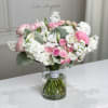 This mixed flower bouquet with pink roses, white matthiolas, and other flowers