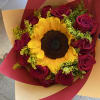 1 sunflower in the middle of a dozen(12) roses (color of roses