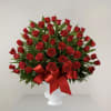 Crafted with deep red roses, this elegant arrangement pays a heartfelt tribute