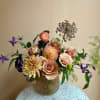 A gathering of blooms in shades of champagne and peach in a