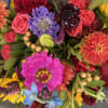 A combinations of bright and colorful spring flowers 9&quot;Glass vase