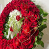 This dramatic and luxurious wreath combines the timeless beauty of red roses