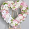 This heart-shaped arrangement is a touching tribute made with a harmonious blend