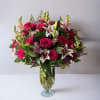 Roses, lilies, alstroemeria, snapdragons, and waxflower come together in an array of