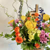 A beautifully bright floor basket is captured in this stunning arrangement with