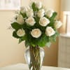 One dozen long stem white roses masterfully arranged in a glass vase