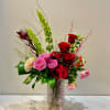 A luxurious blend of rich red roses and elegant pink blooms, designed