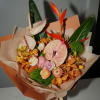 A tropical statement bouquet in rich shades of peach, blush, orange, and