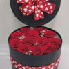 12 preserved roses complimented with preserved baby&#039;s breath, in a black hat