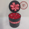 12 preserved roses complimented with preserved baby&#039;s breath, in a black hat