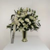 An elegant look to this all white with greenery floral arrangement. 