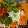 Bright colored flowers with different sized Mums and bright greenery. (flowers will